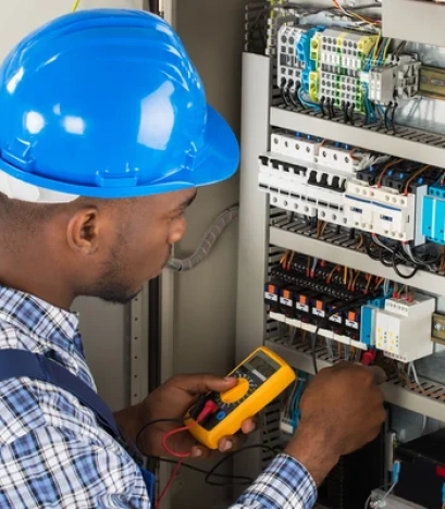 depositphotos_117548858-stock-photo-technician-examining-fusebox-with-multimeter